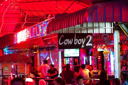 Bangkok, Thailand - February, 25th 2014: Capture of guests, mostly Thai people of bar in Soi Cowboy. Name is Cowboy 2. Early evening and night shot.