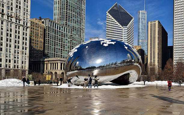 The Bean Chicago city Chicago, USA - February 18, 2014:Tourist visiting "The Bean"(Cloud Gate) one of the main attractions of the city in winter season.Created by Anish Kapoor for the Millenium Park. millennium park stock pictures, royalty-free photos & images