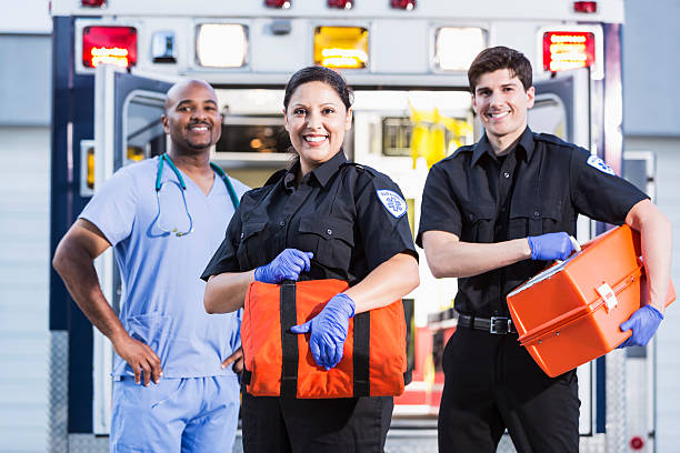 Paramedics and doctor outside ambulance