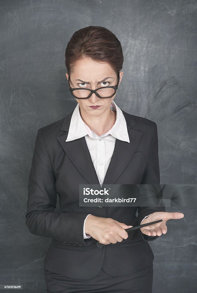 Strict teacher with pointer Strict teacher with pointer looking at someone Females Stock Photo