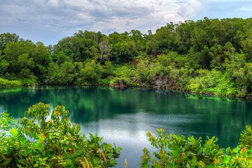 Green Blue water lagoon in Pulau Ubin Singapore. Picturesque with forest and beautiful sky.