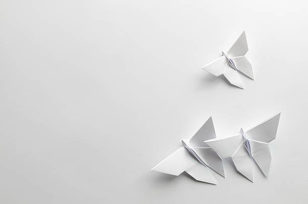 istock White origami butterflies on white background 476102834
