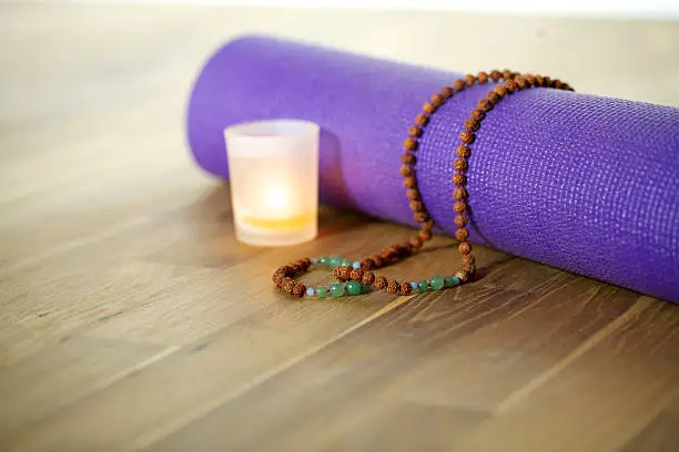 Yoga mat with rudraksha and jade beads.