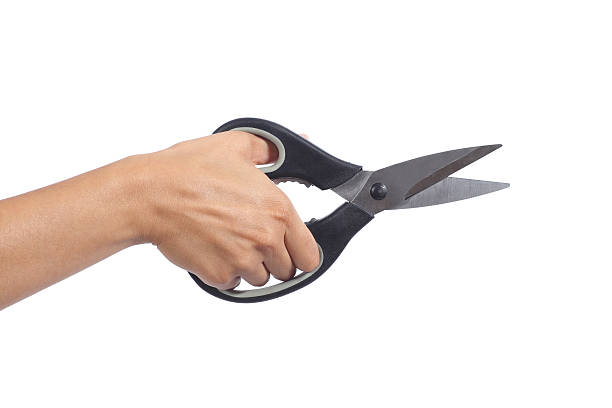 istock Woman hand holding a kitchen scissors 476107475