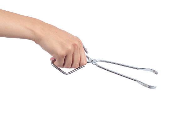 Woman hand using an opened kitchen tongs