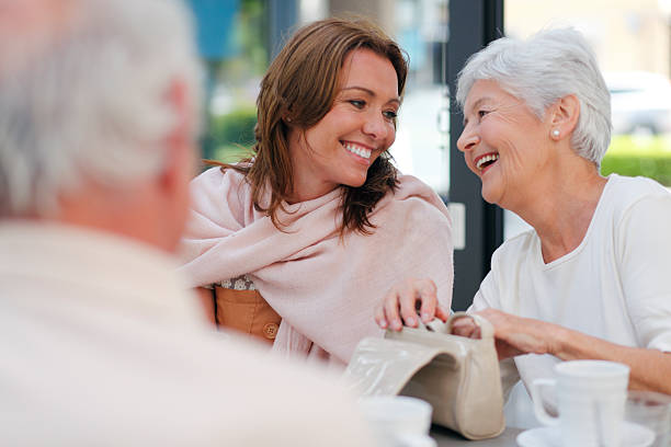 istock Mother and dauther smiling in a coffee shop 476107698