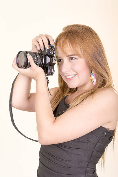 istock pretty young woman with camera 476107717