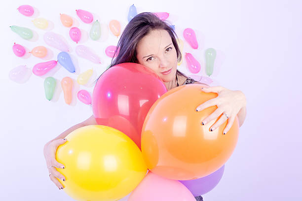istock happy cute woman with balloons 476107733