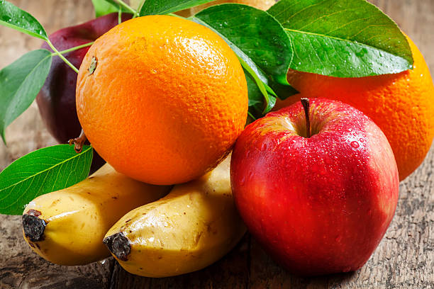 istock Colored fruits on wooden table 476108182