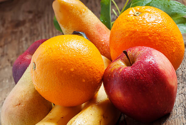 istock Colored fruits on wooden table 476108218