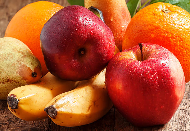 istock Colored fruits on wooden table 476108332