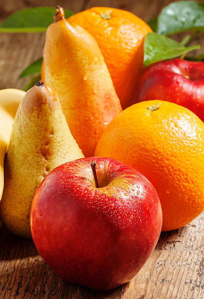 istock Colored fruits on wooden table 476108346