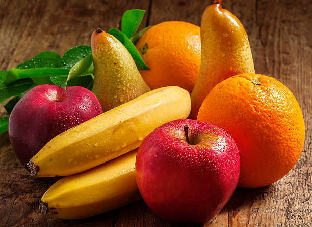 istock Colored fruits on wooden table 476108360