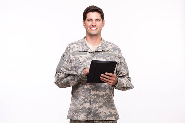 istock Smiling young soldier posing with a digital tablet 476108515