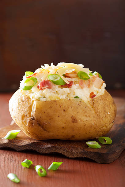 istock baked potato in jacket with bacon and cheese 476109950
