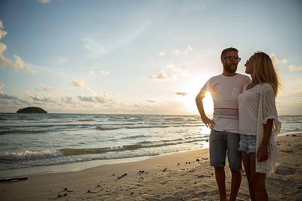 istock Couple on the beach at sunset communicating their love 476110936