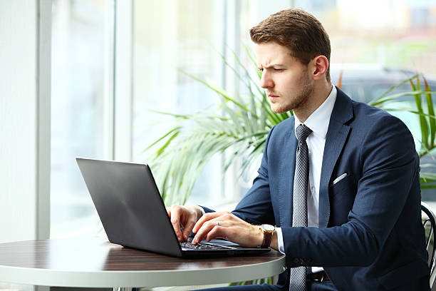 istock image of a pensive businessman in a cafe 476110984