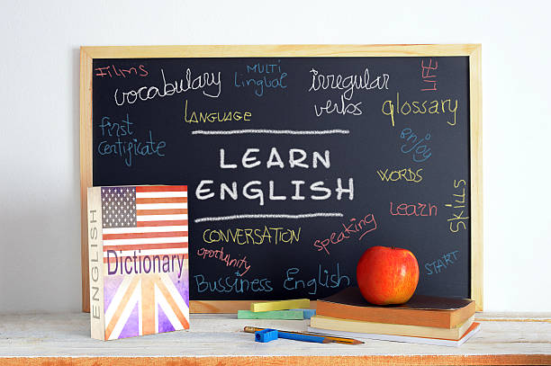 Blackboard and school material in an English class Blackboard in an English class. American and British English. Some books and school stuff for studying English language in a classroom. english culture stock pictures, royalty-free photos & images
