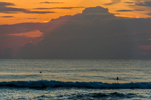 istock Surfer in water at sunrise 476112772