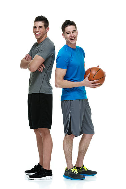 istock Two friends standing and holding basketball 476116014