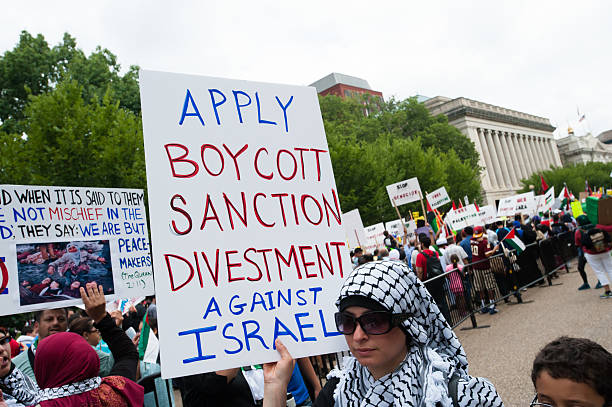 Portrait of young man holding a poster during environmental protest