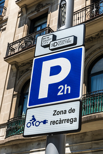 Barcelona, Spain - May 26, 2015: Signal indicating an electric charging station for electric motorbikes and cars with parking for two hours