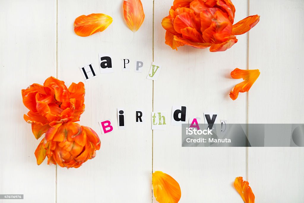Happy Birthday Letters Cut out from Magazine and Orange Tulip 2015 Stock Photo