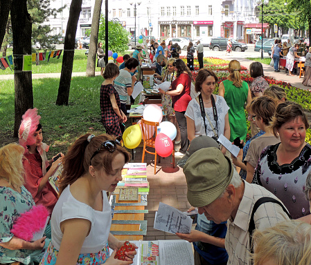 Voronezh, Russia - May 27, 2015: Visitors of the book festival have a good look at books on the stalls in the public garden