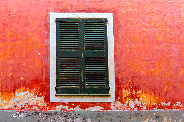 Menorca Ciutadella red grunge facade window shutters at Balearic islands