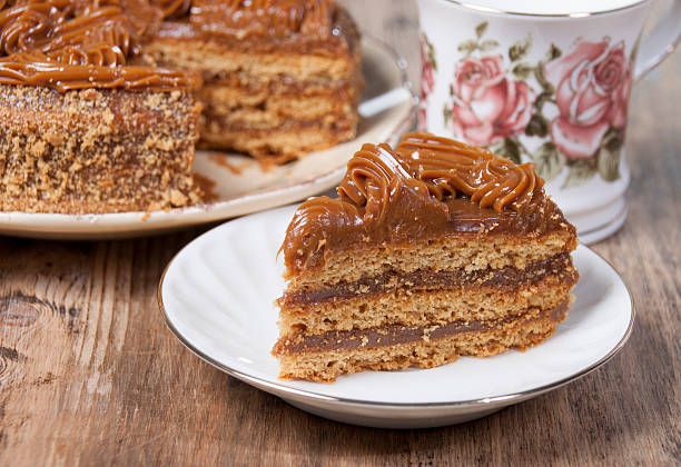 Piece of cake with honey shortcakes  on a white plate. stock photo