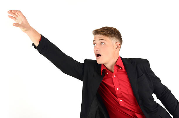 Young business man reaching up in desperation. stock photo