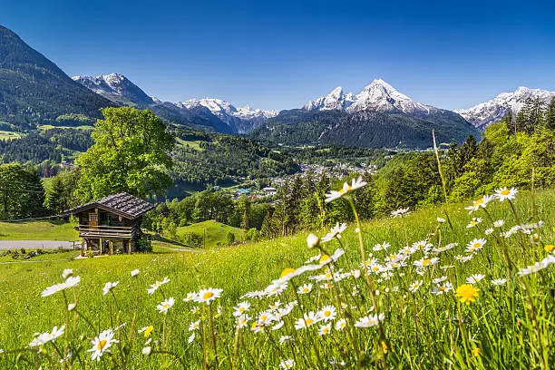 Beautiful mountain landscape in the Bavarian Alps with village of Berchtesgaden and Watzmann massif in the background at sunrise, Nationalpark Berchtesgadener Land, Bavaria, Germany.