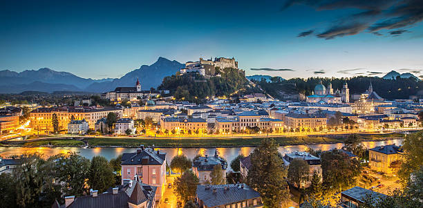 Historic city of Salzburg at dusk, Salzburger Land, Austria Panoramic view of the historic city of Salzburg with Hohensalzburg Fortress at dusk, Salzburger Land, Austria. wolfgang amadeus mozart photos stock pictures, royalty-free photos & images