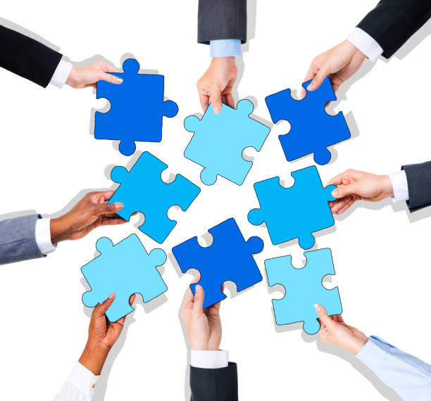 istock Group of Hands Holding Colorful Jigsaw Pieces 476129780