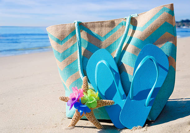 istock Beach bag with flip flops by the ocean 476132943