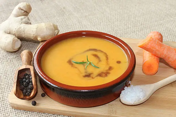 healthy carrot soup with ingredients around