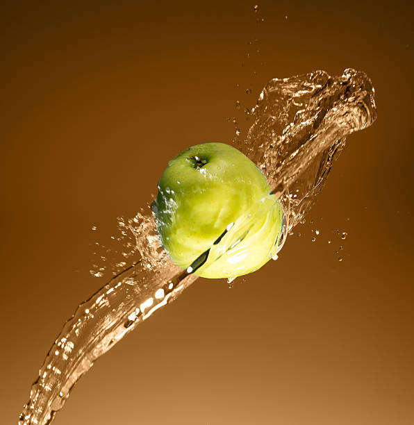istock Green apple with water splash, on beige 476139692