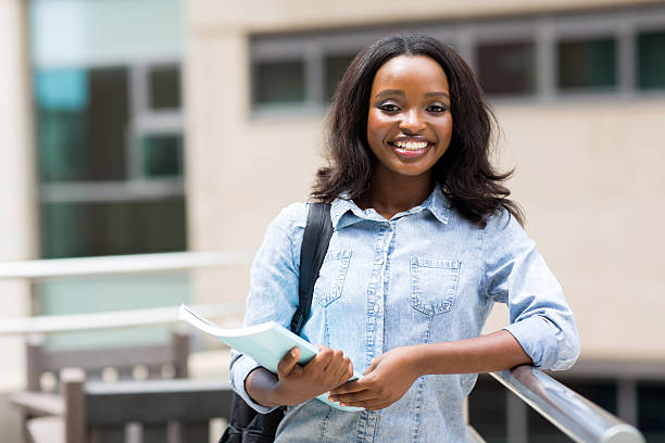 istock afro american college student holding a book 476140226