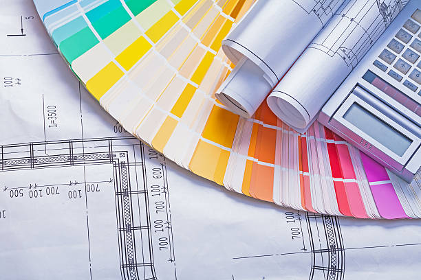 istock rolled bueprints and calculator on color palette 476140240