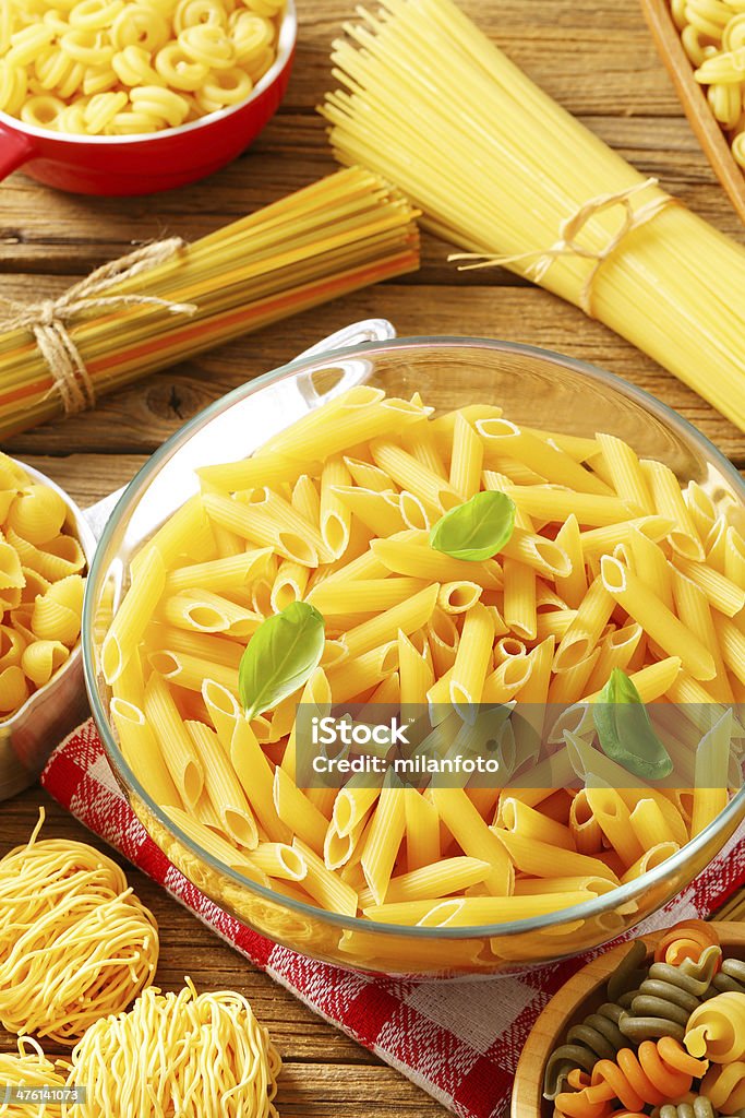 assorted pasta various shapes of raw pasta on wood Basil Stock Photo