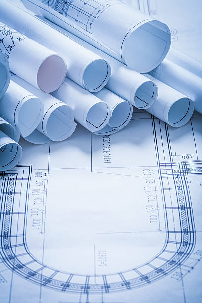 istock Pile of rolled up construction plans building and architecture c 476144648