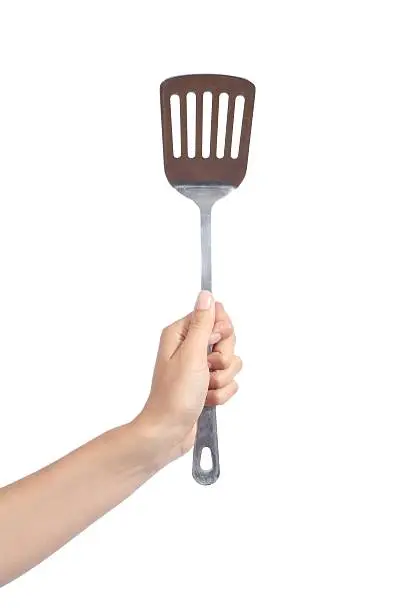 Woman hand holding a spatula isolated on a white background