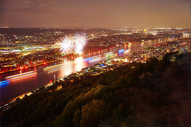 Beautiful views of an illuminated city. In front of it, colorfully lit ships pass by in a parade. Fireworks set the last highlight.