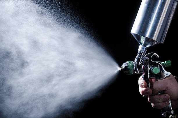 istock Spray gun in hand on dark background 476146797
