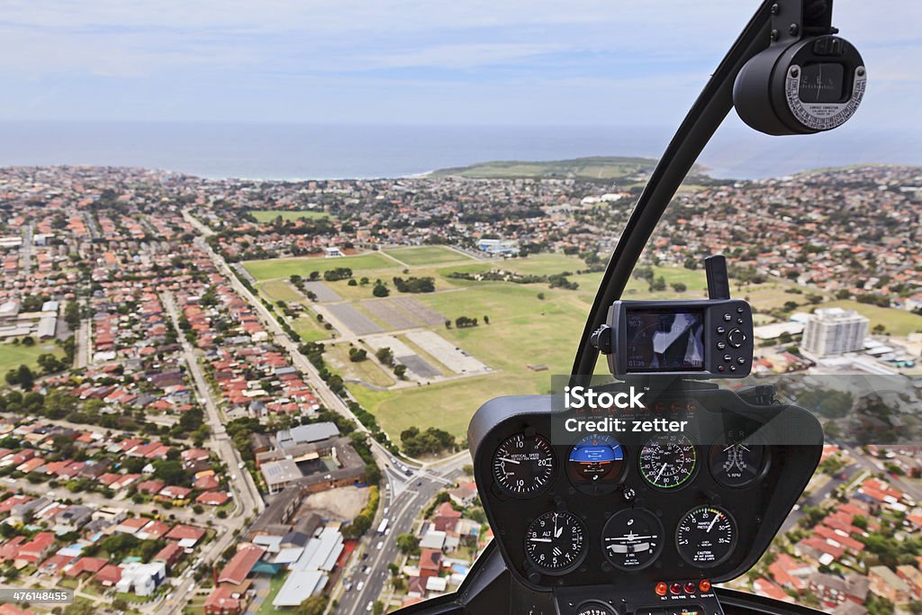 Helicopter Cabin Flight Australia Helicopter flight over SYdney residential areas and suburbs mid-air aerial view from cockpit with control dashboard Helicopter Stock Photo