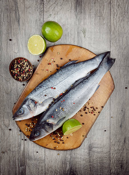 istock Raw seabass fish on the wooden board 476149268