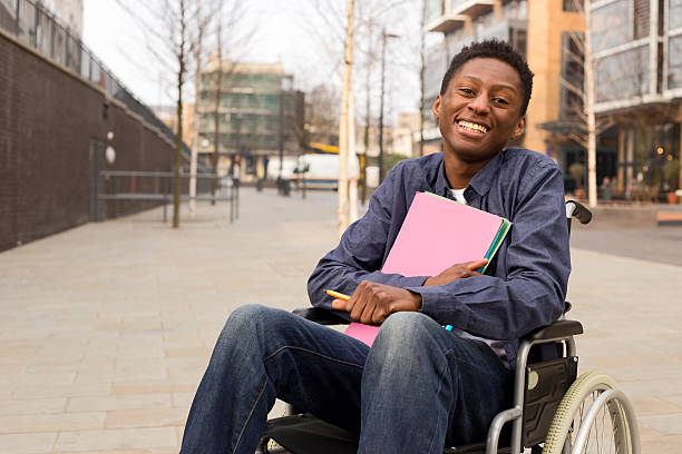 student in a wheelchair a young student in a wheelchair male likeness stock pictures, royalty-free photos & images