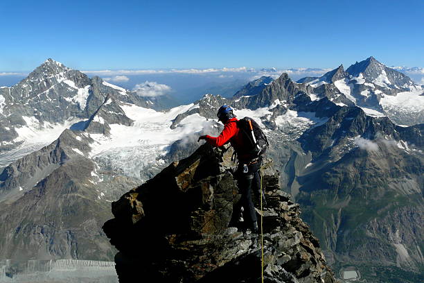 Climber on his way to Matterhorn's summit through Hornli ridge Climber on his way to Matterhorn's summit through Hornli ridge, Zermatt, Switzerland matterhorn stock pictures, royalty-free photos & images