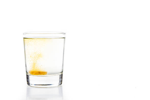 istock Effervescent vitamin C tablet bubbles in glass of water 476150502