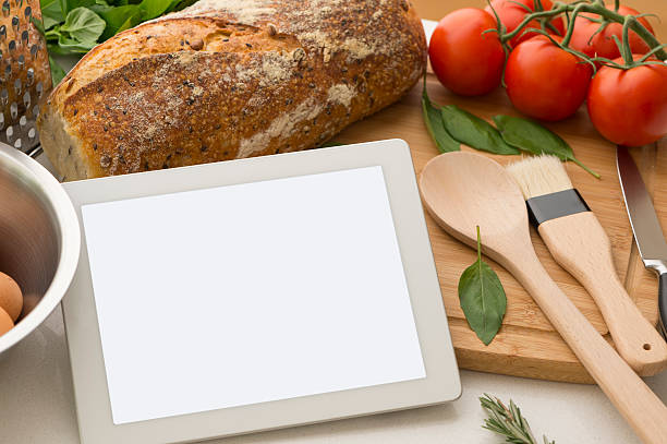 istock Digital tablet in kitchen with food and blank screen 476150797